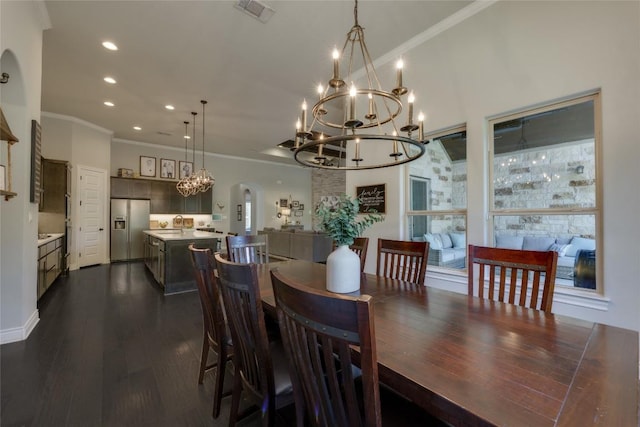 dining area with visible vents, arched walkways, a notable chandelier, ornamental molding, and recessed lighting