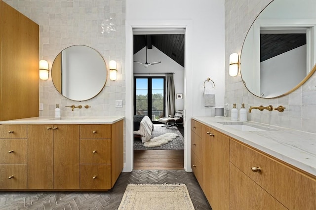 bathroom with tasteful backsplash, two vanities, and a sink