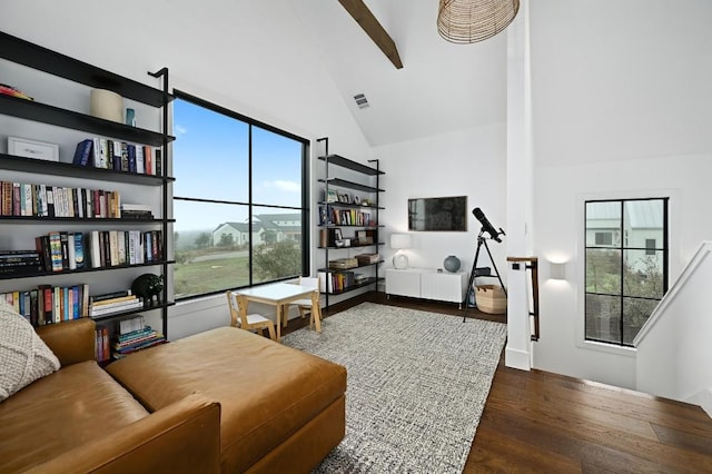 living area featuring high vaulted ceiling, dark wood-style flooring, and visible vents