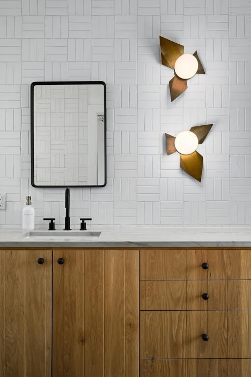 bathroom featuring vanity and decorative backsplash