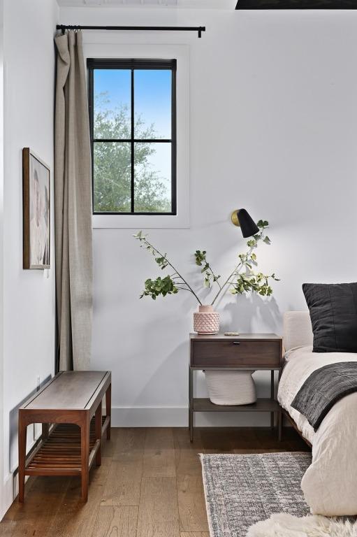 living area featuring hardwood / wood-style flooring and baseboards