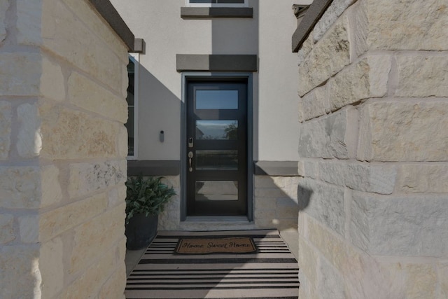 116 Evening Star Ln, Georgetown, TX 78628 - doorway to property featuring stone siding and stucco siding