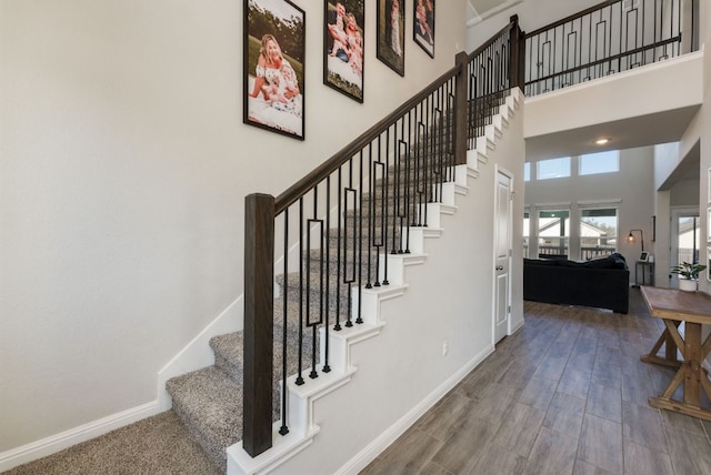 116 Evening Star Ln, Georgetown, TX 78628 - staircase with a high ceiling, baseboards, and wood finished floors
