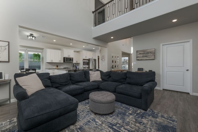 116 Evening Star Ln, Georgetown, TX 78628 - living room featuring dark wood-type flooring, baseboards, a high ceiling, and recessed lighting