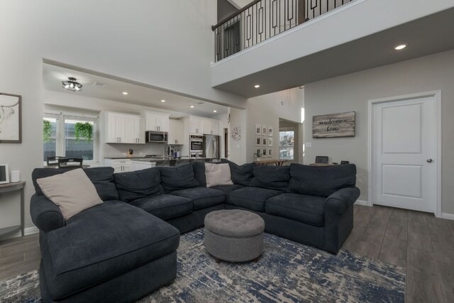 116 Evening Star Ln, Georgetown, TX 78628 - living area featuring dark wood finished floors, baseboards, a high ceiling, and recessed lighting