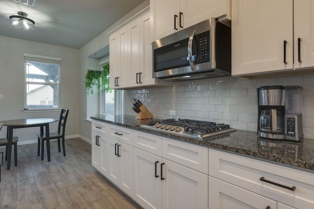 116 Evening Star Ln, Georgetown, TX 78628 - kitchen featuring stainless steel appliances, baseboards, white cabinets, and backsplash