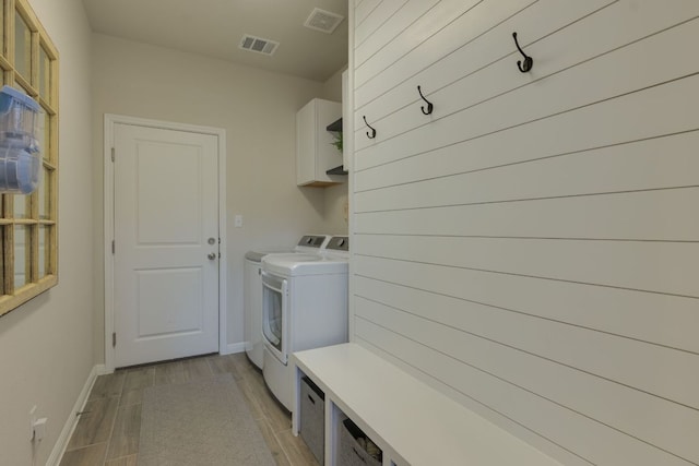 116 Evening Star Ln, Georgetown, TX 78628 - washroom with washer and dryer, baseboards, light wood-type flooring, and cabinet space