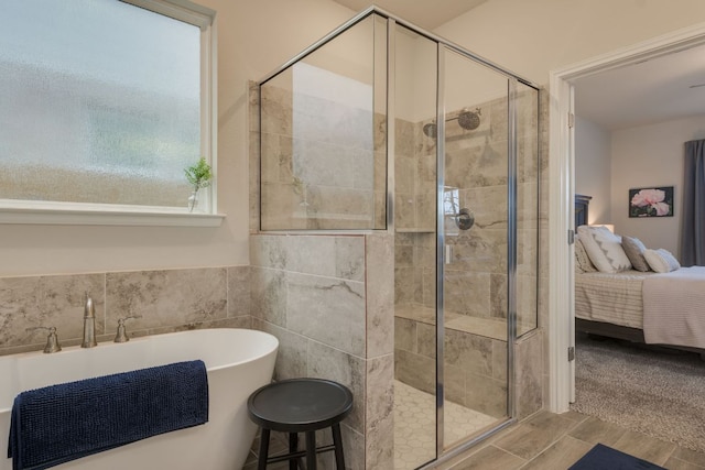 116 Evening Star Ln, Georgetown, TX 78628 - ensuite bathroom with a freestanding tub, a shower stall, and tile walls
