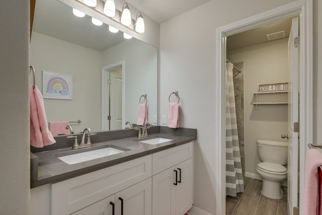 116 Evening Star Ln, Georgetown, TX 78628 - bathroom featuring toilet, double vanity, a shower with curtain, and baseboards