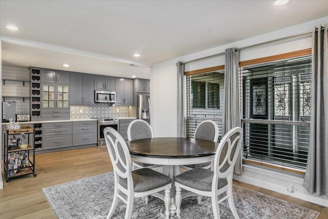 dining room featuring light wood-style floors, a wealth of natural light, and recessed lighting