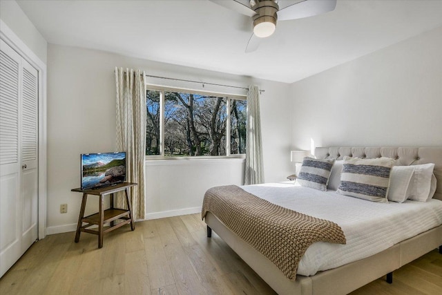 bedroom featuring light wood-style floors, ceiling fan, and baseboards