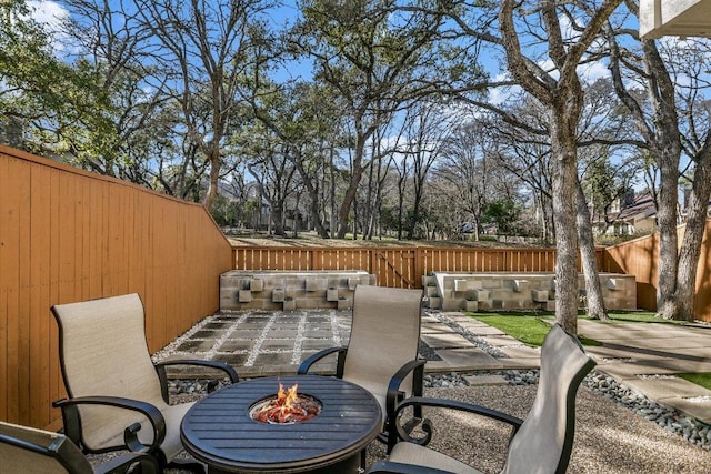 view of patio / terrace with a fire pit and a fenced backyard