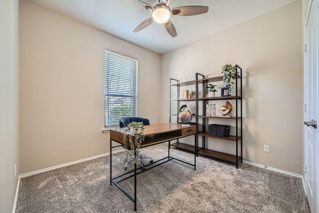 office space featuring carpet floors, baseboards, and a ceiling fan