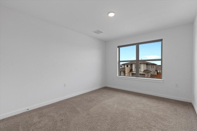 carpeted spare room with visible vents, recessed lighting, and baseboards