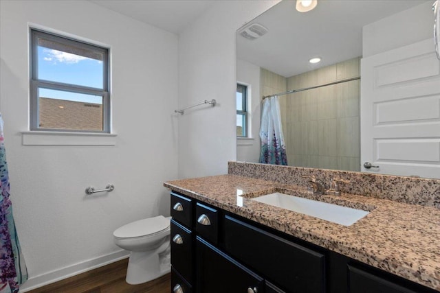 full bathroom featuring baseboards, wood finished floors, a healthy amount of sunlight, and toilet