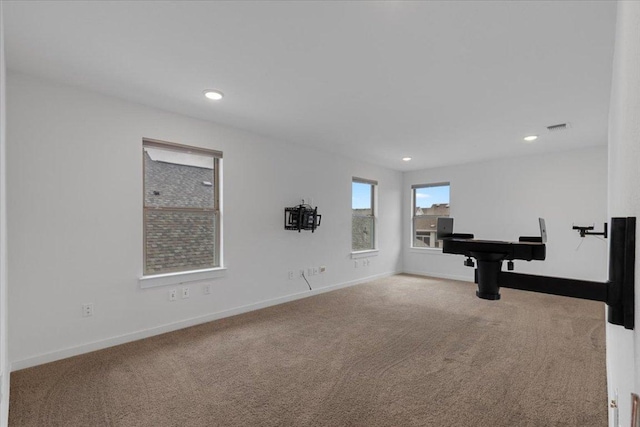interior space featuring recessed lighting, baseboards, visible vents, and carpet