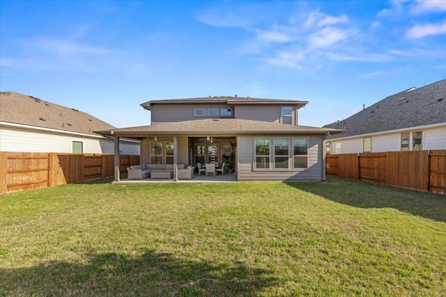 rear view of house with a yard, ceiling fan, outdoor lounge area, and a fenced backyard