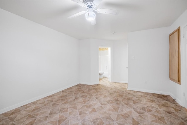 empty room featuring baseboards and a ceiling fan