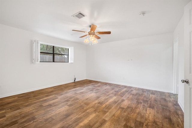 unfurnished room with ceiling fan, wood finished floors, visible vents, and baseboards