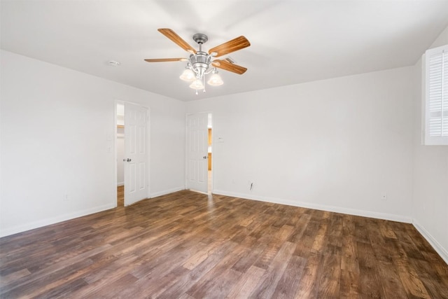 spare room with a ceiling fan, baseboards, and wood finished floors