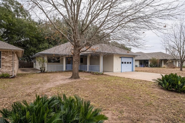 single story home featuring a porch, concrete driveway, an attached garage, and stucco siding