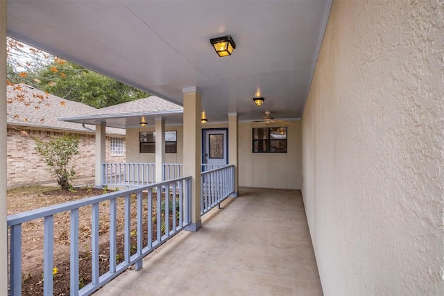 property entrance featuring a shingled roof and brick siding