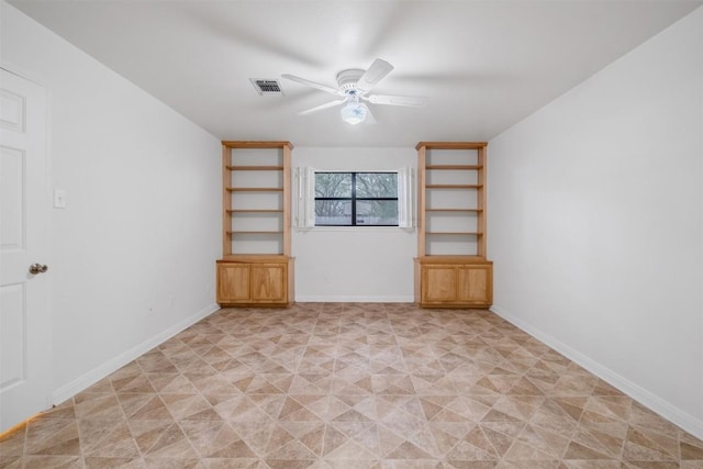 unfurnished room with ceiling fan, visible vents, and baseboards