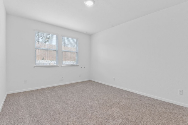 spare room with carpet floors and baseboards