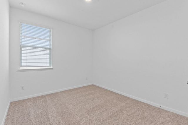 spare room with carpet floors and baseboards