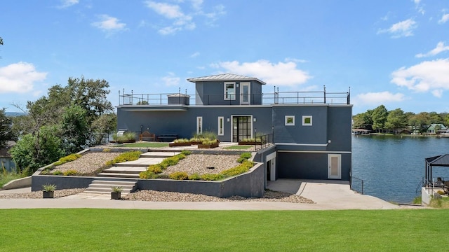 view of front of house with a balcony, a front lawn, and stucco siding