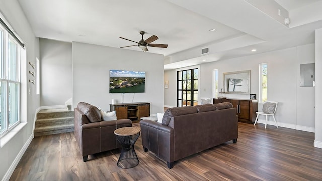 living room with dark wood-style floors, stairs, visible vents, and baseboards