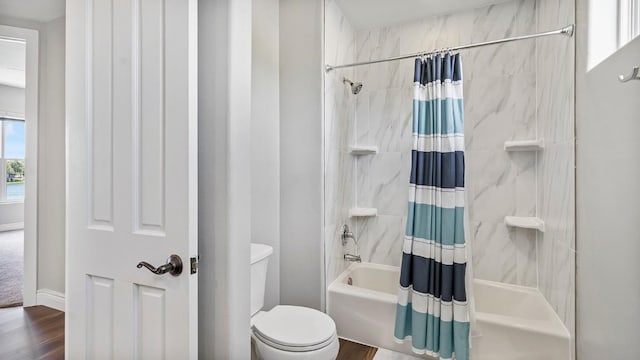 bathroom with shower / bath combination with curtain, toilet, and wood finished floors