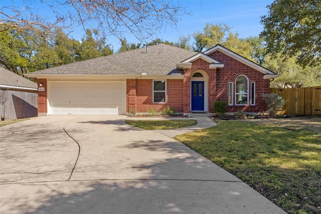 single story home with a garage, fence, a front lawn, and concrete driveway