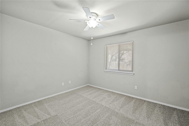 empty room featuring carpet, baseboards, and ceiling fan