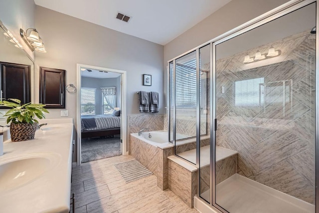 bathroom with a garden tub, connected bathroom, visible vents, a shower stall, and double vanity