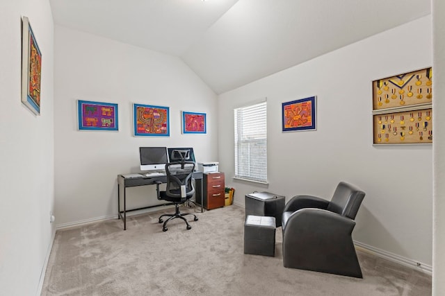 carpeted office space featuring baseboards and vaulted ceiling