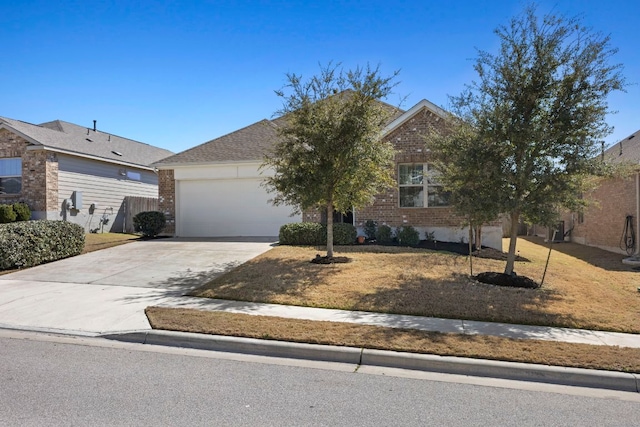 view of front of home with driveway, brick siding, and an attached garage