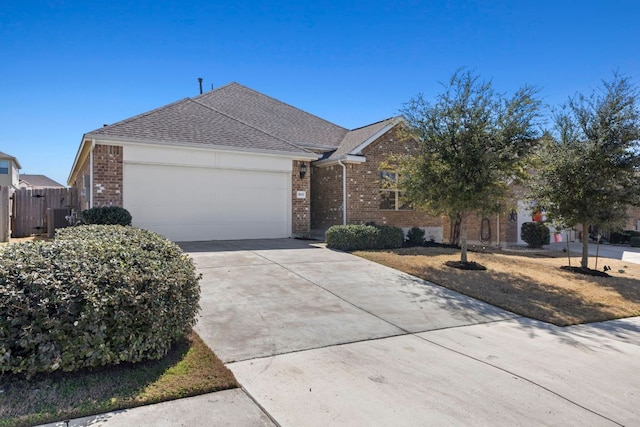 ranch-style house with brick siding, a shingled roof, an attached garage, fence, and driveway