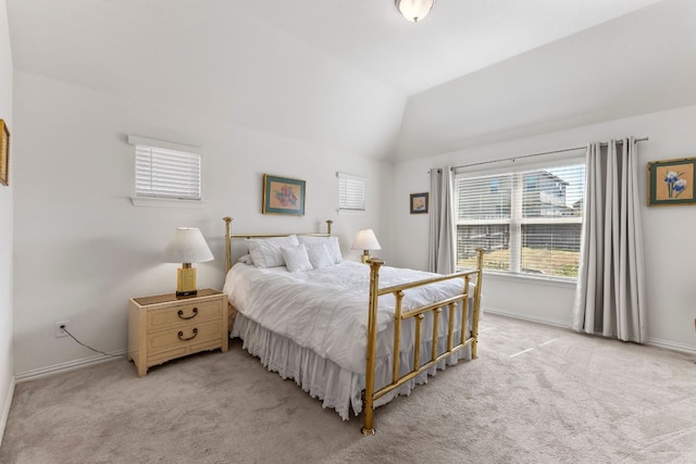 bedroom with light carpet, baseboards, and vaulted ceiling