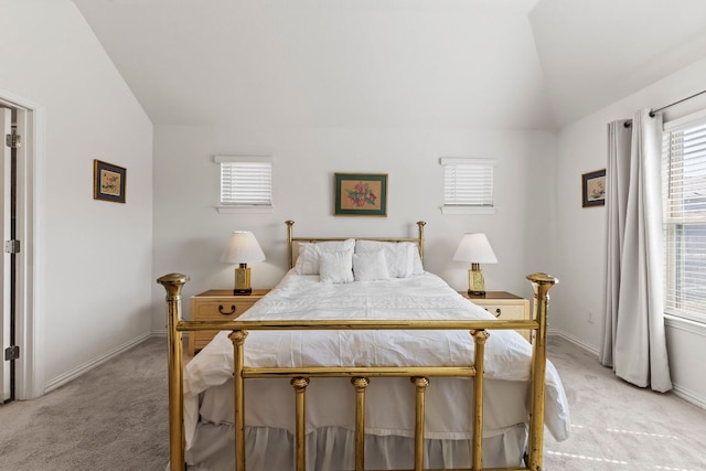 bedroom featuring lofted ceiling, light carpet, and baseboards