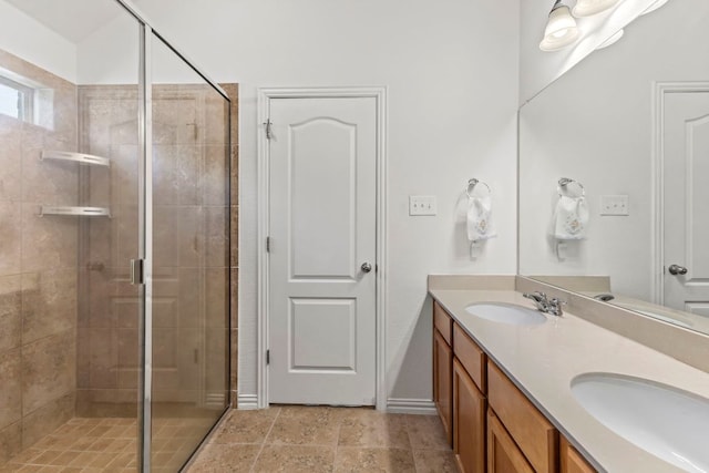 bathroom featuring double vanity, a shower stall, and a sink