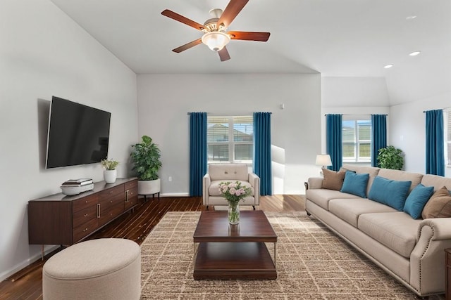 living area with a ceiling fan, baseboards, and wood finished floors