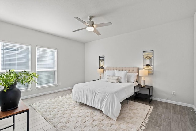 bedroom featuring ceiling fan, wood finished floors, and baseboards