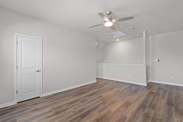 interior space featuring visible vents, attic access, a ceiling fan, wood finished floors, and baseboards