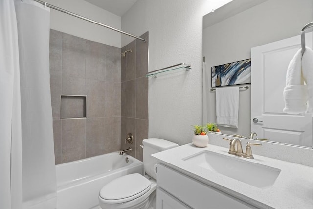 bathroom featuring shower / bath combination with curtain, a textured wall, vanity, and toilet