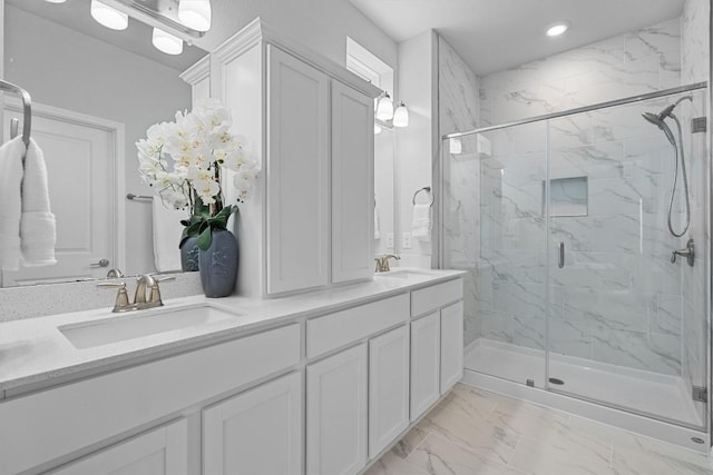 full bathroom featuring marble finish floor, double vanity, a sink, and a marble finish shower