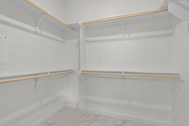 spacious closet featuring marble finish floor