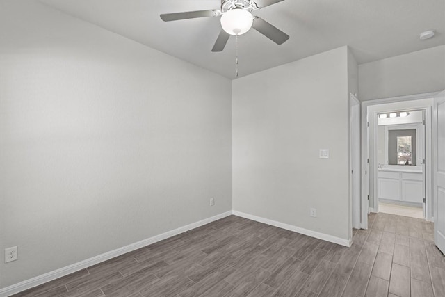 unfurnished room featuring ceiling fan, wood finish floors, and baseboards