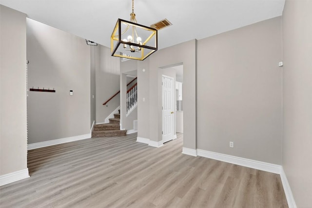5008 Barlow Dr, Round Rock, TX 78681 - unfurnished dining area featuring wood finished floors, a chandelier, and stairs