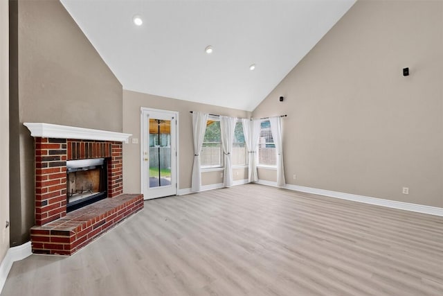 5008 Barlow Dr, Round Rock, TX 78681 - unfurnished living room with wood finished floors, high vaulted ceiling, a brick fireplace, and recessed lighting